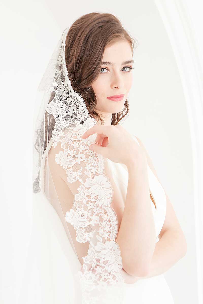 Side view of bride wearing Peyton cathedral length mantilla wedding veil from Laura Jayne Accessories Toronto. 