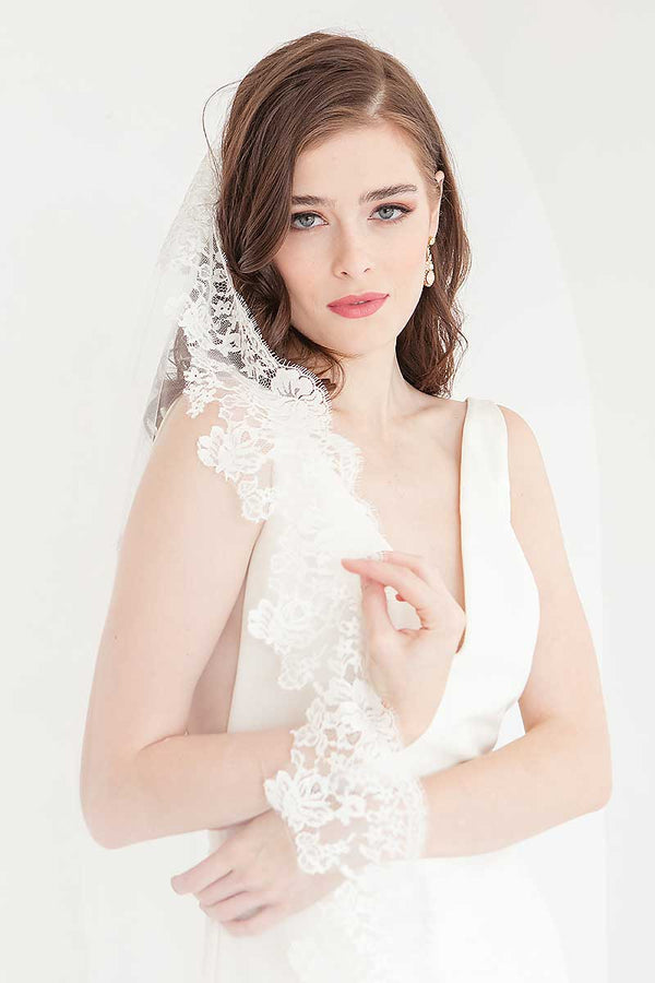 Front view of bride wearing Peyton cathedral length mantilla wedding veil.
