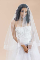 Bride wearing cathedral horsehair veil with blusher over face. Laura Jayne Heather veil.