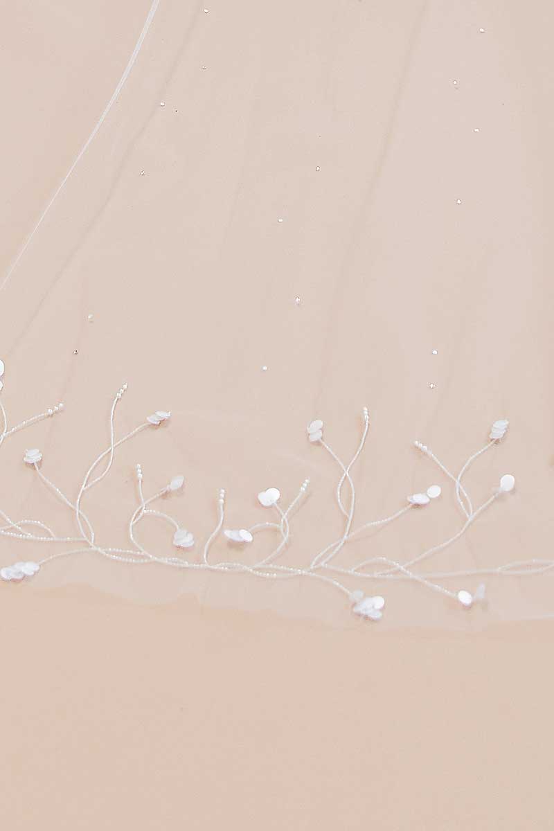 Close up view of pearl and paillette beaded details on Liliya Cathedral Veil by Laura Jayne Accessories.
