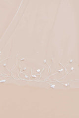 Close up view of pearl and paillette beaded details on Liliya Cathedral Veil by Laura Jayne Accessories.