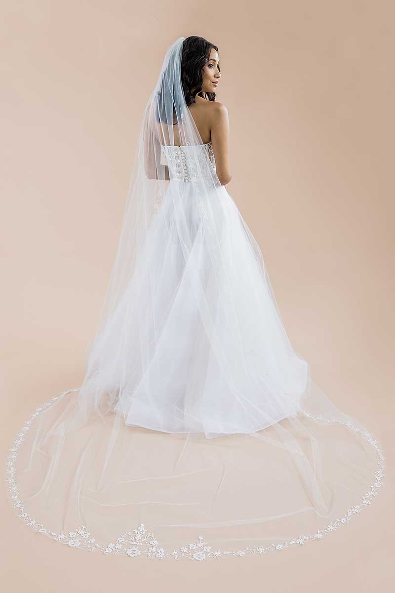 Full back view of a modern romantic bride's cathedral length train with a pretty border of beaded flowers and vines. Bisous Floral Cathedral Veil by Laura Jayne Accessories Toronto. Handmade in Canada.