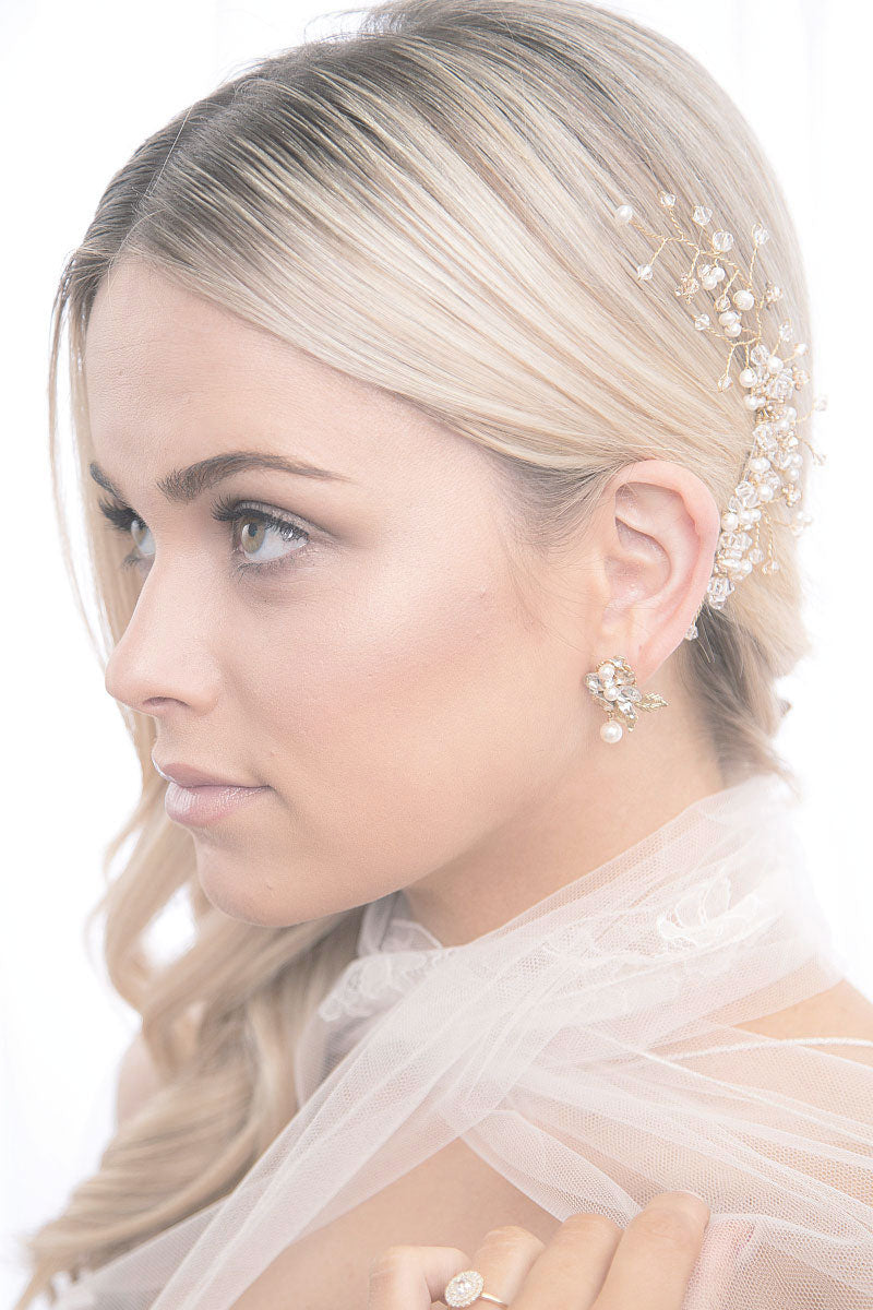Profile of woman wearing gold pearl crystal vine bridal hair accessory by Laura Jayne