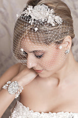 Side profile of bride wearing Celeste flower hair comb with birdcage veil. Laura Jayne Accessories Toronto. Handcrafted in Canada.