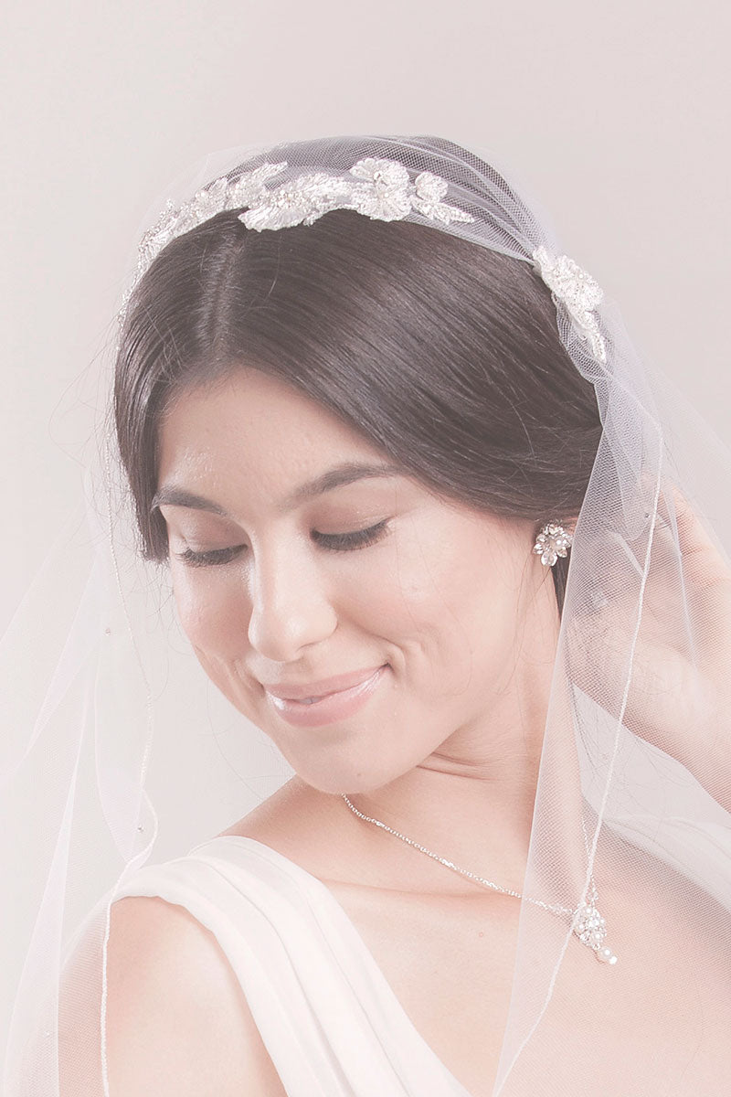 Bride wearing boho inspired fingertip length Juliet veil with hand-embroidered and beaded flower butterfly details at the crown. Cerie Juliet Veil made in Canada by Laura Jayne Accessories Toronto. 