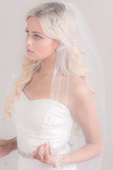 Modern romantic bride wearing a whimsical boho inspired sheer classic cut tulle fingertip length wedding veil. Constance Vine Embroidery Fingertip Veil. Made in Canada by Laura Jayne Accessories Toronto.