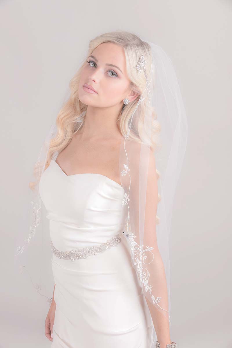 Modern romantic bride wearing the whimsical boho inspired Constance Vine Embroidery Fingertip Veil with beaded flourishes. Handcrafted in Canada by Laura Jayne Accessories Toronto.