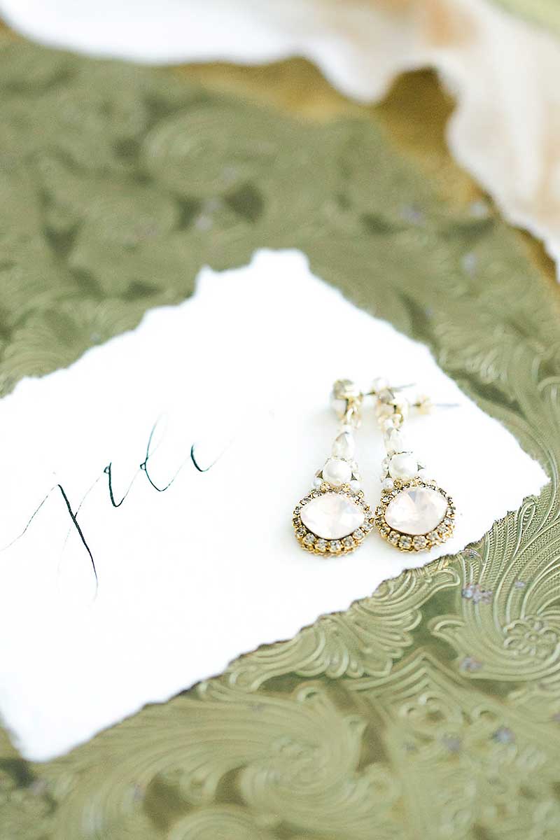 Rose blush crystal and pearl dangle bridal earring. Handmade in Toronto wedding jewelry. Dramatic bridal earring trend. Earrings as featured in wedluxe magazine.