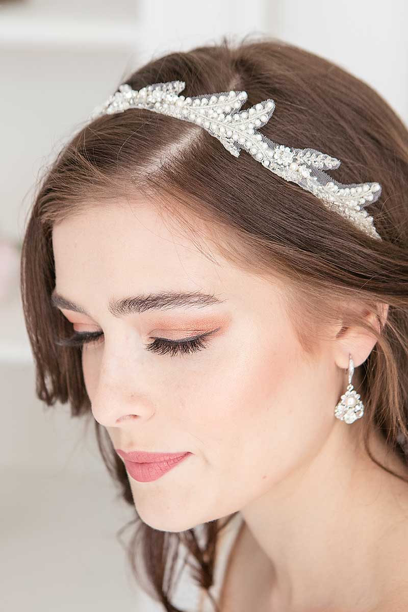 Close up of woman wearing Ferra tulle pearl hair ribbon by Laura Jayne Accessories