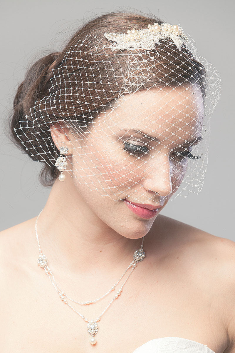 Woman wearing a chic face veil with French netting and a hand-beaded motif of crystal leaves & flowers with pearls. Katie Face Veil. Laura Jayne Accessories Toronto. Handcrafted in Canada.