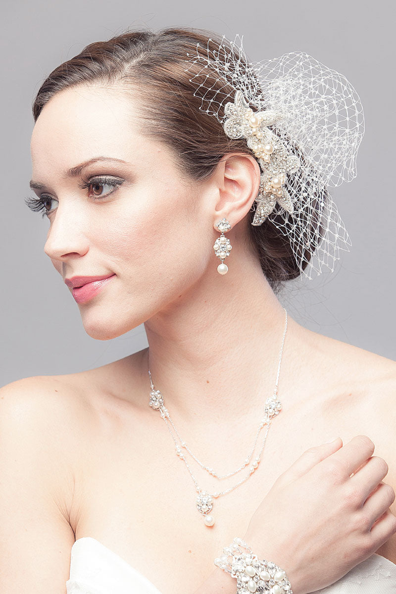 Romantic bride wearing vintage-inspired birdcage veil with French netting and a hand-beaded motif of crystal leaves & flowers with pearls. Katie Face Veil. Laura Jayne Accessories Toronto. Handcrafted in Canada.
