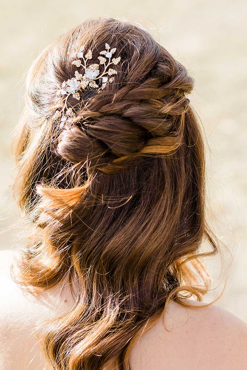 Back of woman's head with braid hairstyle wearing Kristin gold leaf bridal comb by Laura Jayne Accessories