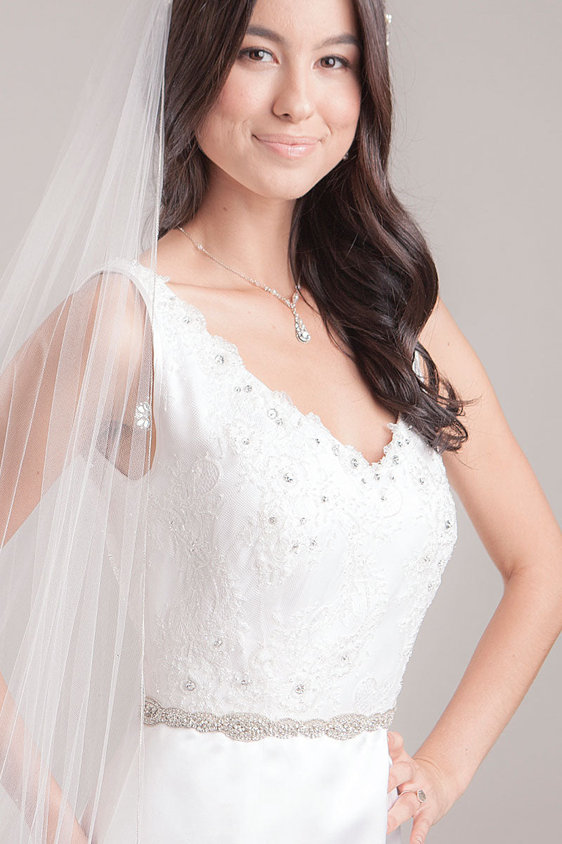 Torso of bride wearing Maggie crystal rondelle sash by Laura Jayne Accessories