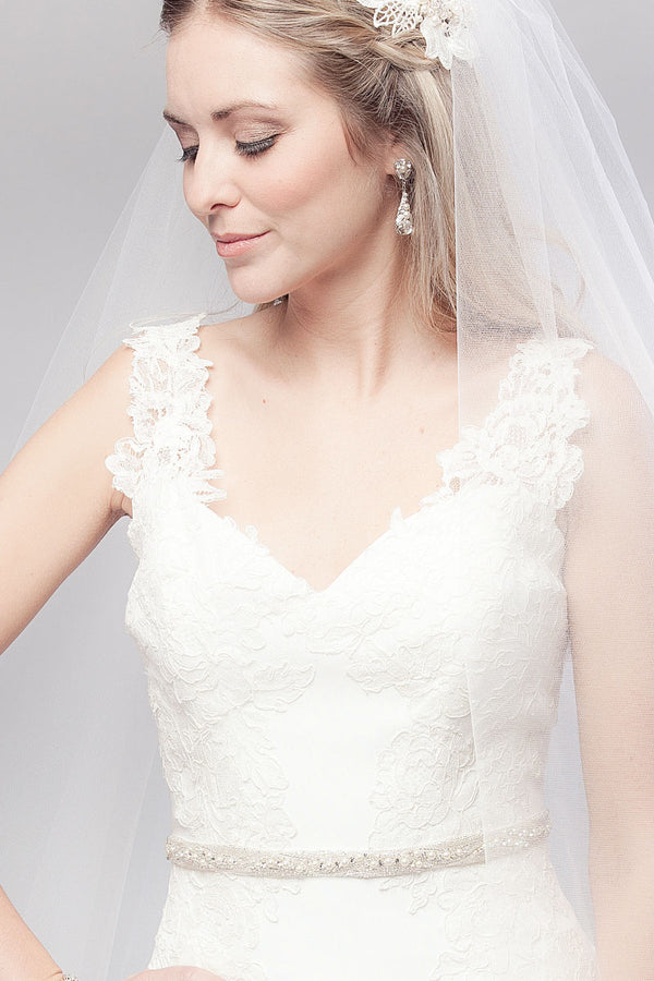 Bride looking down wearing pearl crystal wedding belt Metropolitan by Laura Jayne Accessories