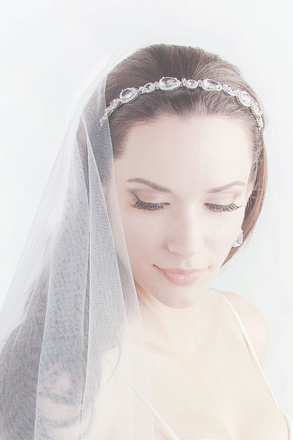 Bride with head down wearing pear oval CZ headband Rafaella by Laura Jayne Accessories