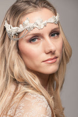 Front profile view of woman wearing beaded forehead headband bridal headpiece with side draped chains