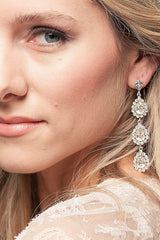woman wearing crystal drop earrings