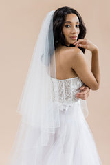 profile of bride looking pensive wearing 2 tier cathedral wedding veil by Laura Jayne