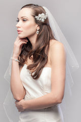 Modern minimalist bride wearing simple yet feminine fingertip wedding veil by Laura Jayne. Made in Toronto, Canada.