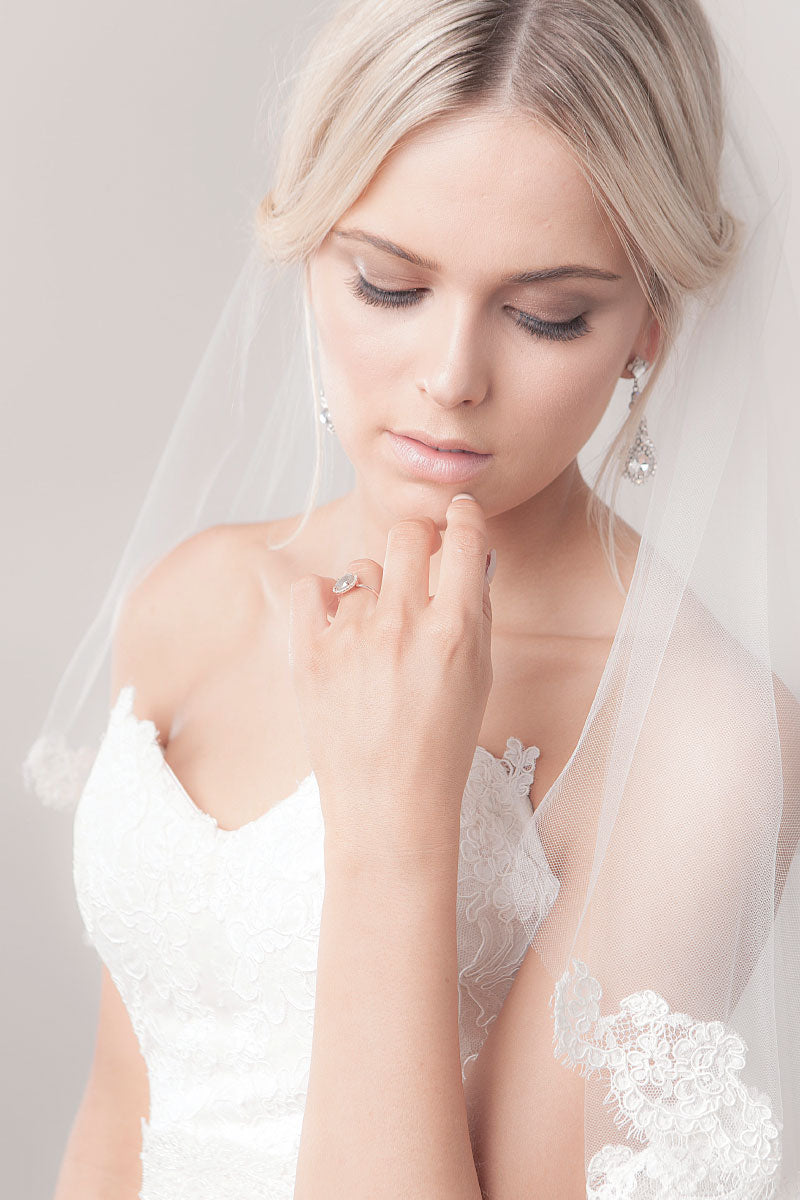 Bride looking down with Marlisa fingertip lace wedding veil over shoulder. Laura Jayne Accessories Toronto, Canada. 