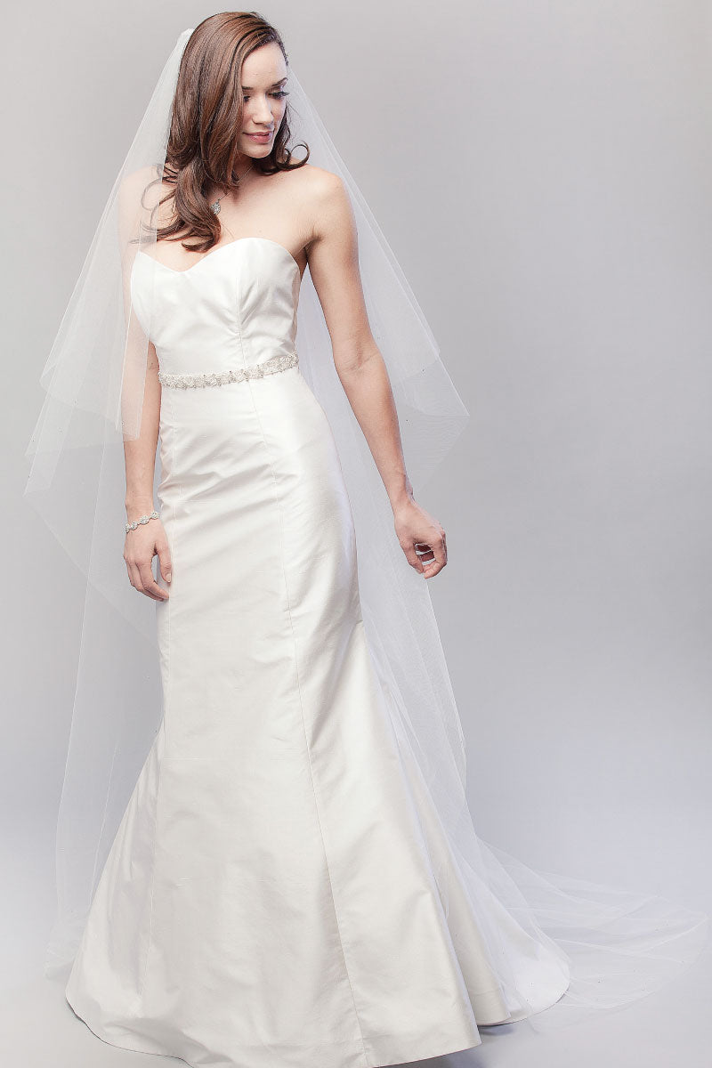 Full length image of modern romantic bride wearing a classic chapel veil with crystal details. Karina Crystal Border Chapel Veil by Laura Jayne Accessories, Toronto, Canada. 