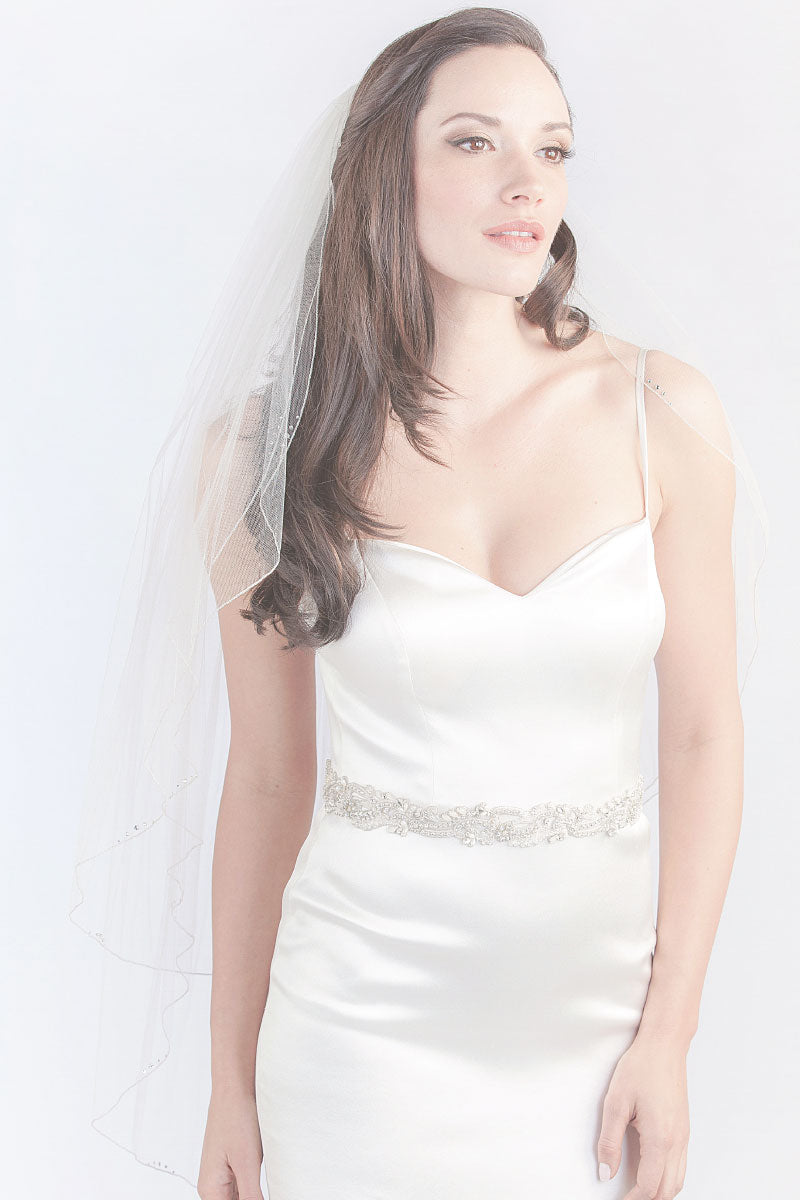 Modern minimalist bride wearing a simple two tier fingertip veil. Corsica Two Tier Fingertip Veil. Laura Jayne Accessories Toronto. Handcrafted in Canada.