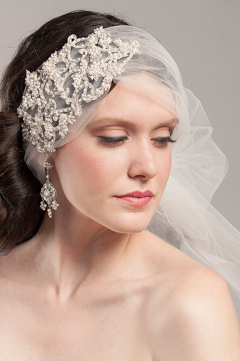 woman wearing tulle headwrap and earring