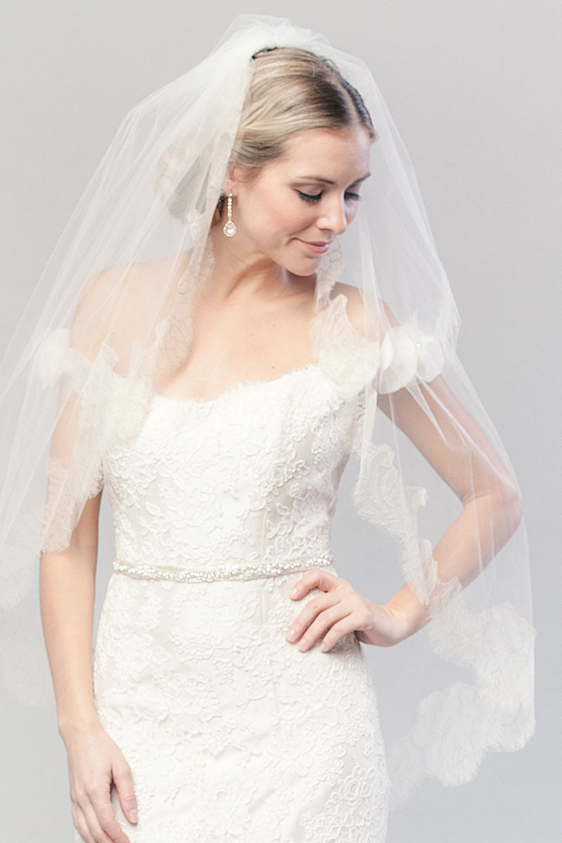 Modern romantic bride wearing a two tier fingertip length veil with blusher and French Chantilly lace edging. Coco Chantilly Fingertip Cage Veil by Laura Jayne Accessories Toronto. Handcrafted in Canada.
