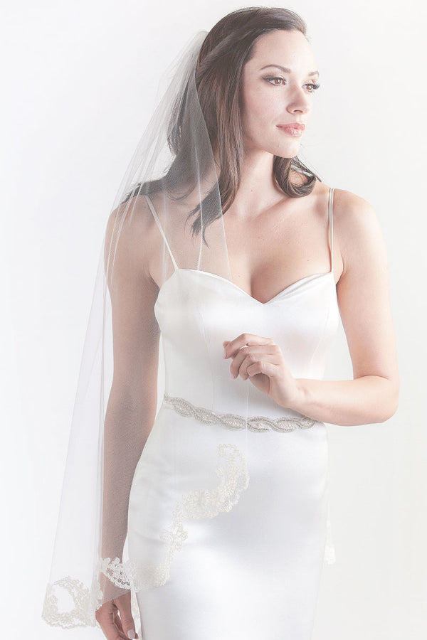 Front side view of bride wearing Laura Jayne Sakura fingertip veil