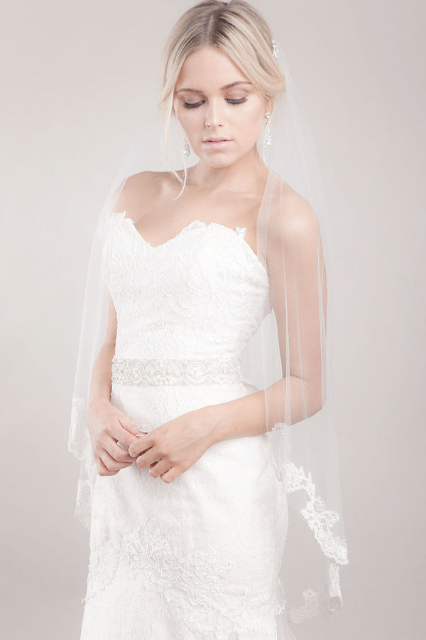 Bride wearing Sakura Alencon lace fingertip veil by Laura Jayne Accessories in Toronto