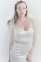 Bride wearing Taylor horsehair fingertip wedding veil by Laura Jayne Accessories Toronto. Handcrafted in Canada.