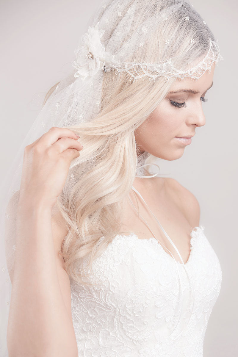 Modern, romantic bride wearing a Juliet cap veil with trellis lace, embroidered flower blossom detail and elbow length tulle. Embroidered Tulle Lace Juliet Cap Veil by Laura Jayne Accessories. Handcrafted in Canada.