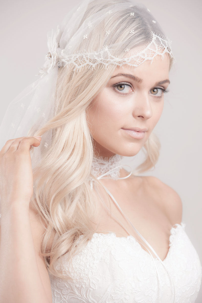 Boho bride wearing a modern take on a Juliet cap veil with trellis lace, embroidered flower blossom detail and elbow length tulle. Embroidered Tulle Lace Juliet Cap Veil by Laura Jayne Accessories. Handcrafted in Canada.