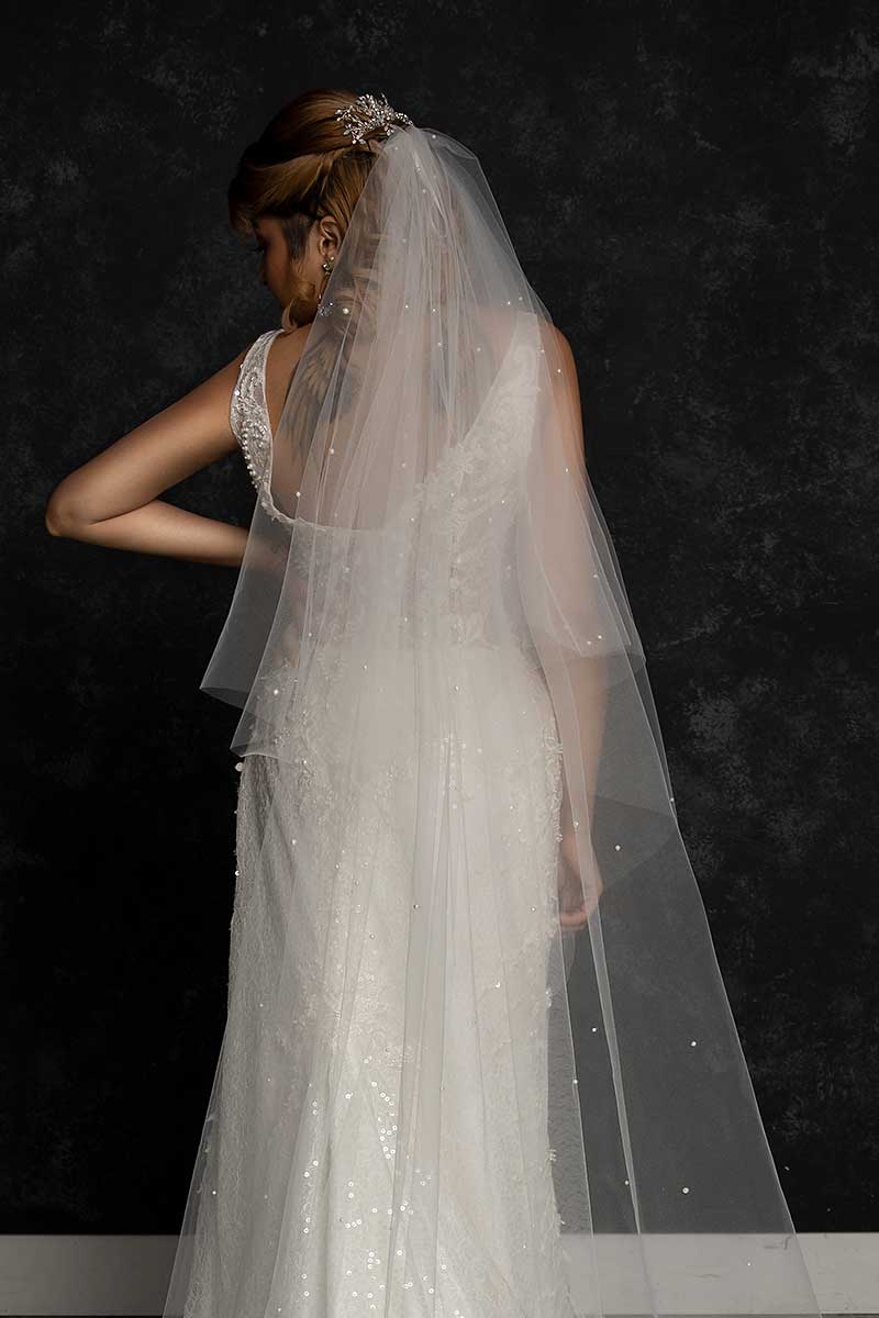 Back view of bride wearing pearl beaded oval cut cathedral veil by Laura Jayne Accessories
