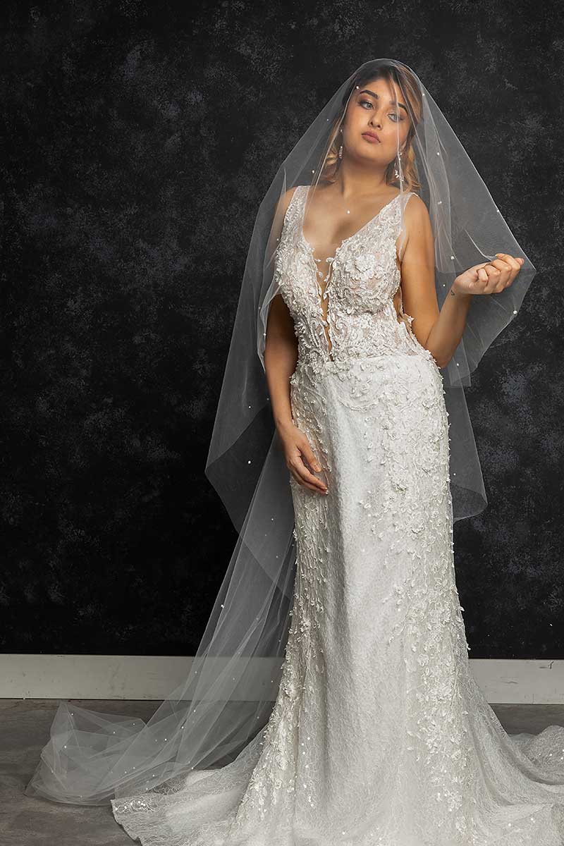 Front view portrait of bride wearing Alayna pearl beaded cathedral wedding veil with blusher Alayna by Laura Jayne Accessories