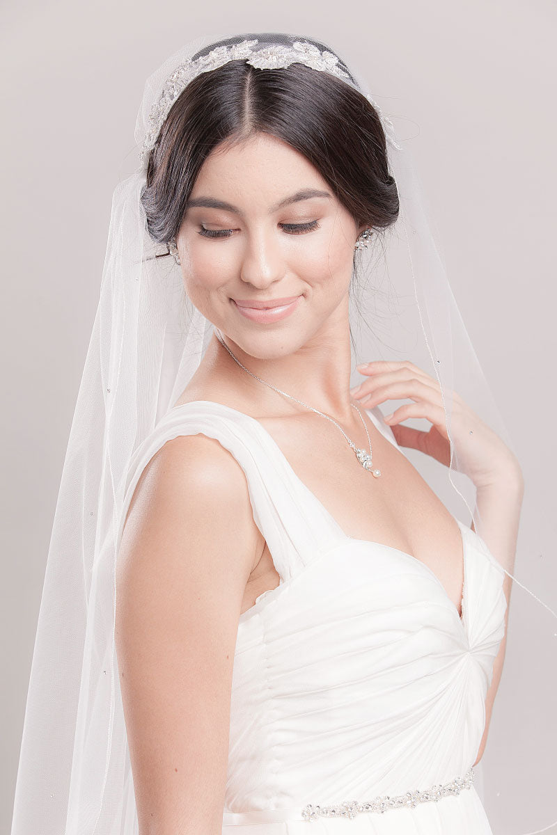 Profile of bohemian bride wearing a romantic and whimsical fingertip veil with delicate, hand-beaded flower details at the crown. Cerie Juliet Veil. Handcrafted by Laura Jayne Accessories in Toronto, Canada. 